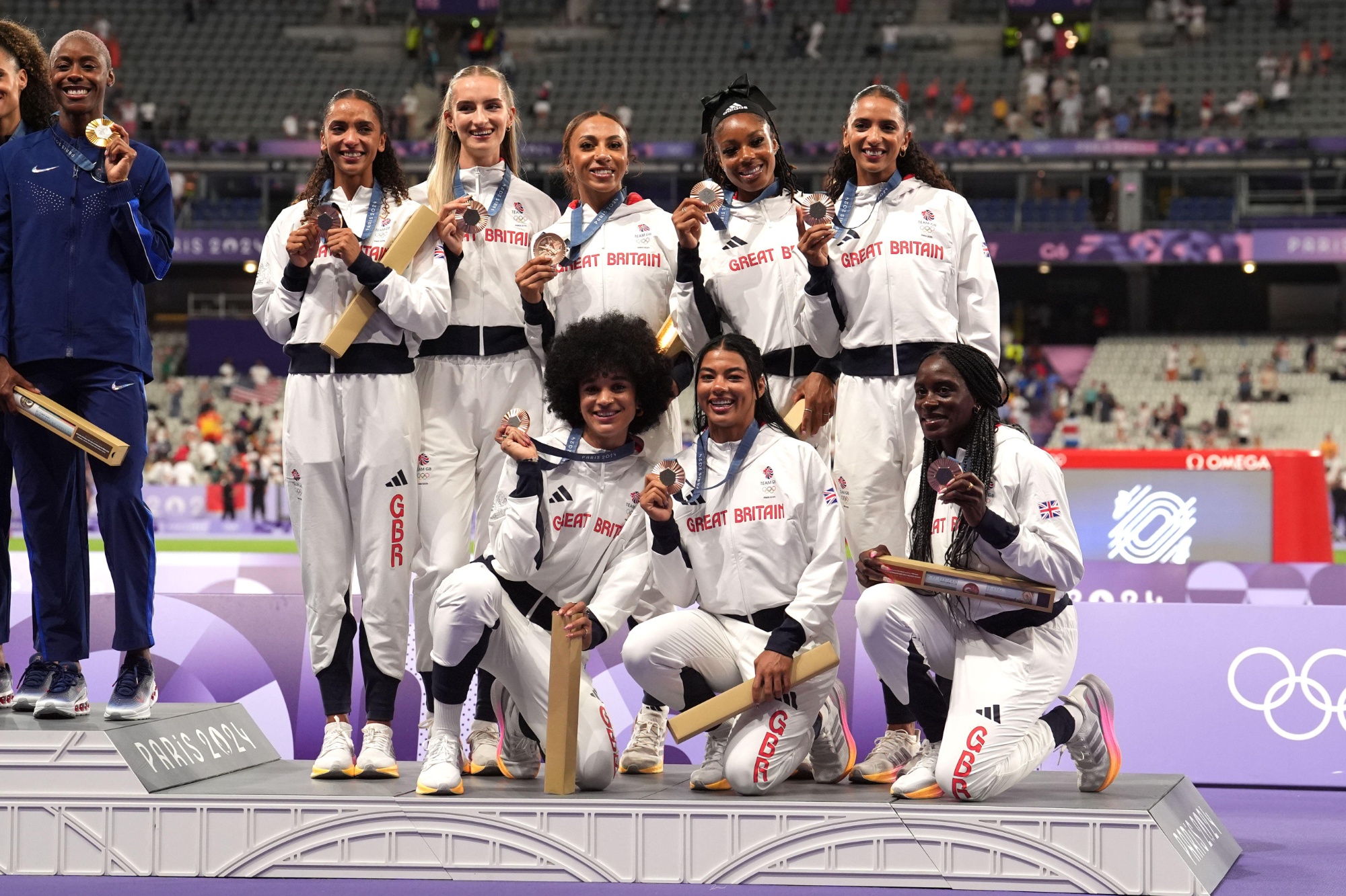 Jodie Williams pictured bottom left with members of Team GB Athletic Squad holding their medals at the Paris Olympics