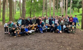 Year 6 pupils pose in a group on the forest floor at Penshurt Place in Kent