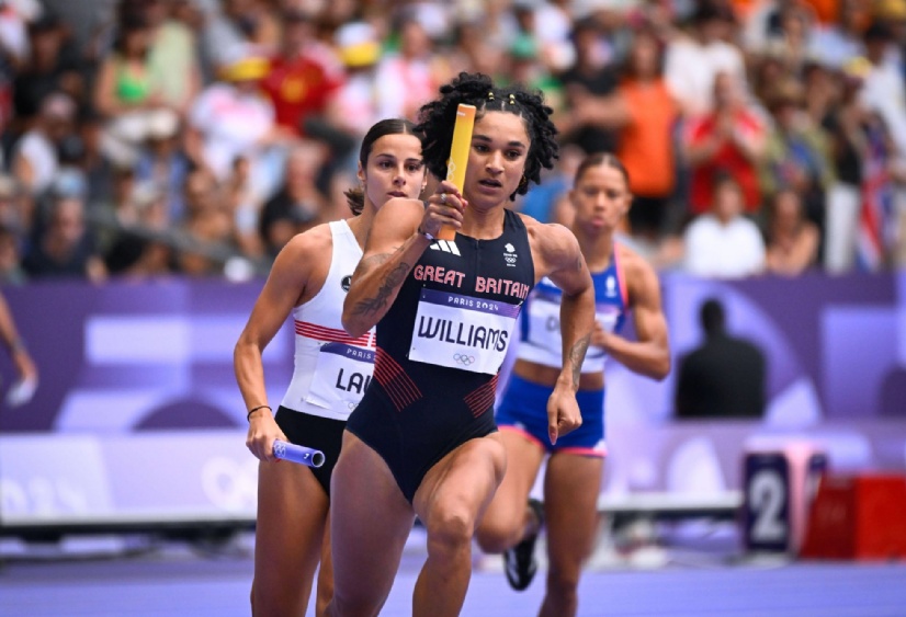 Jodie Williams carries the baton as she runs a leg of the women's 4x400m relay at the Olympics